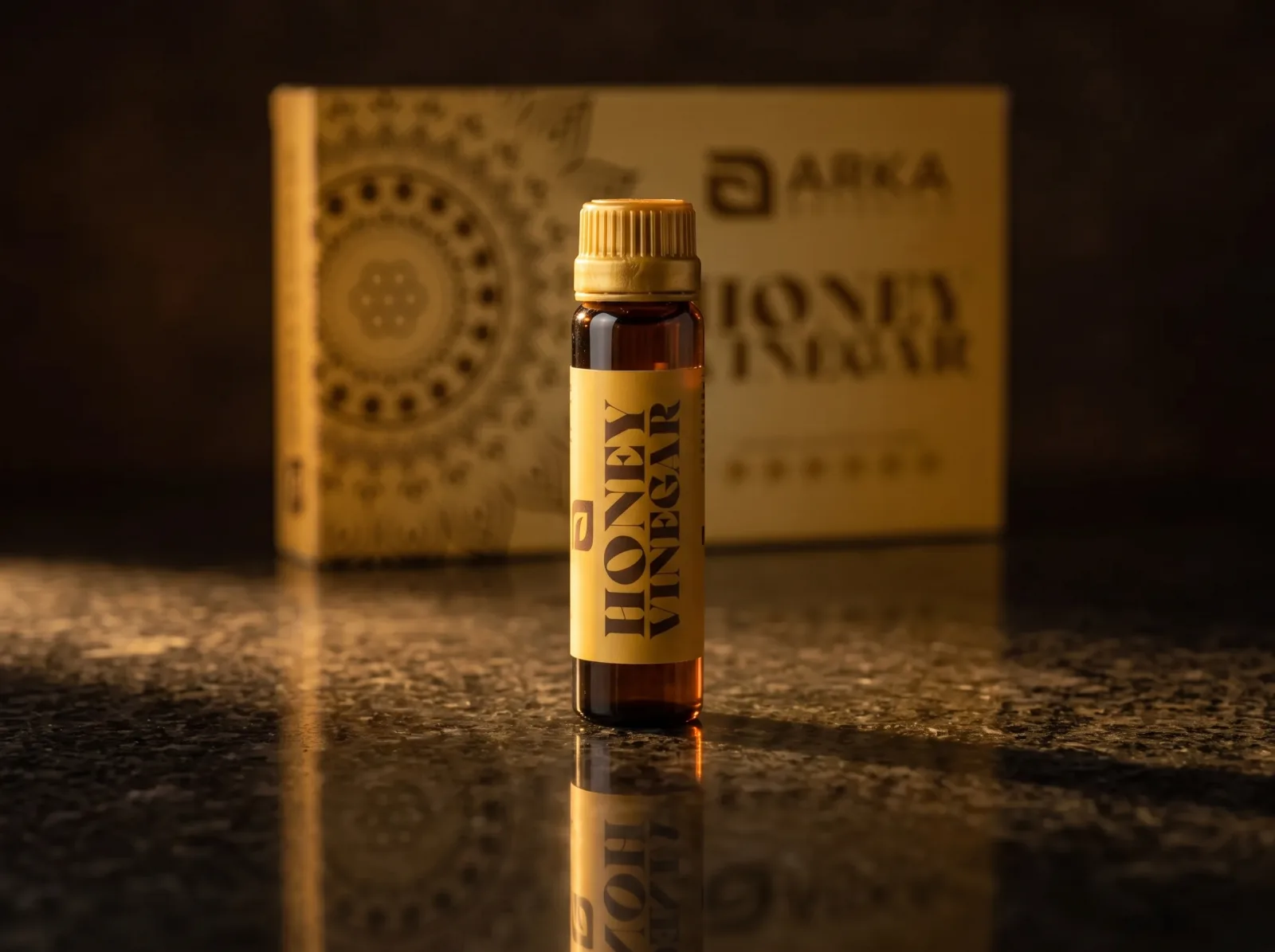 Honey Vinegar bottle and box on a dark reflective surface