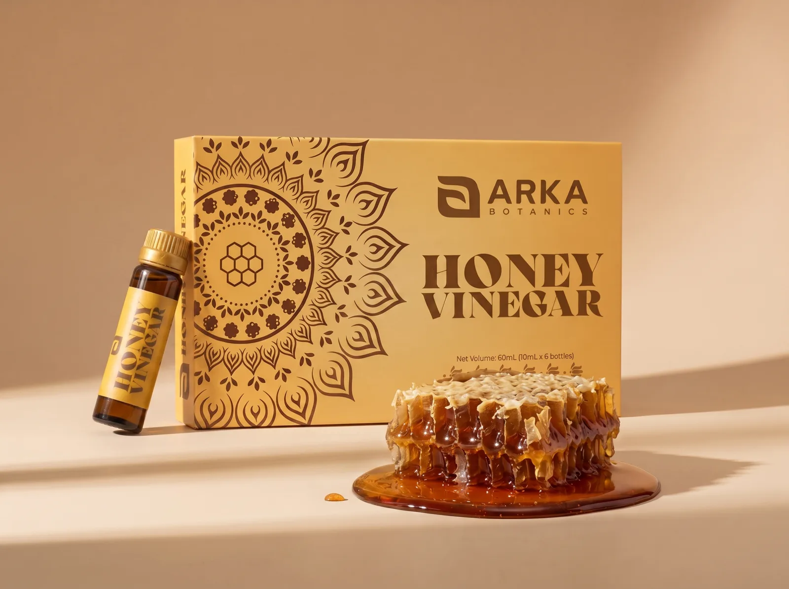 Honey Vinegar box and bottle beside a dripping honeycomb